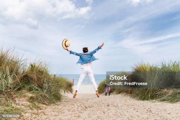 Happy Woman With Straw Hut On Beach Stock Photo - Download Image Now - Beach, Baltic Sea, Vacations