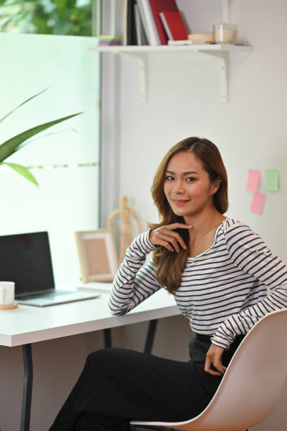 istock Young creative woman sitting on artist workplace and looking at camera. 1172207343