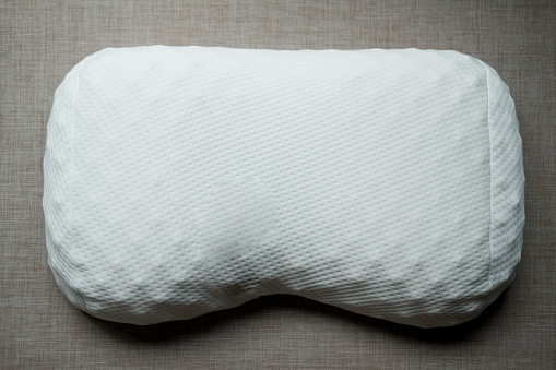 White orthopedic pillow. Physiotherapy concept