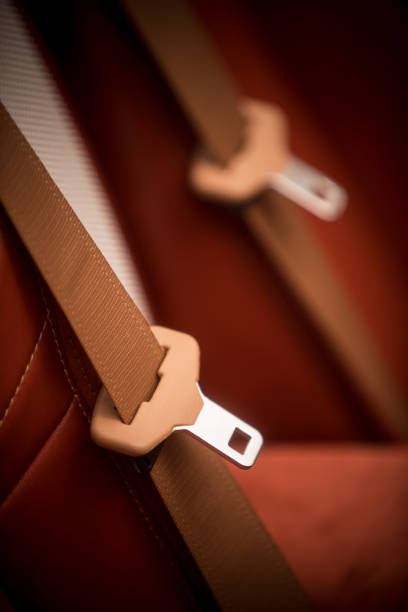 Young man fastening seatbelt in a car