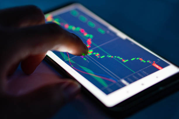 istock Man touch candlestick chart from stock market on smartphone 1172210503