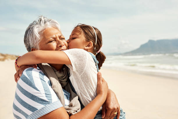 Shot of an adorable little girl having a fun day at the beach with her grandmother