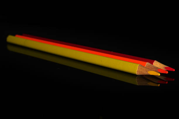 istock Vibrant colored pencil isolated on black glass 1172212273