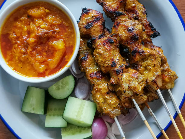 istock Traditional barbecue skewer with peanut sauce and cucumber 1172213351