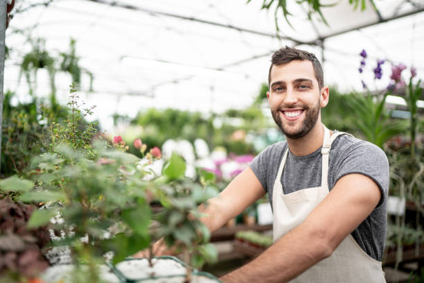 istock Young florist taking care of some seedlings 1172213412