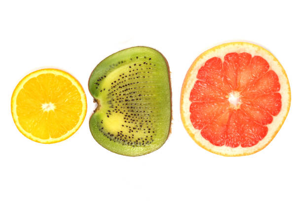 istock cut across different fruit on white background. healthy vitamin food 1172214281