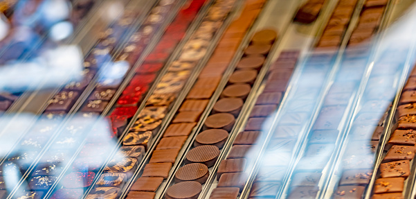 Chocolates in a chocolatier window in Lyon, France. lines of individual chocolates in a store.