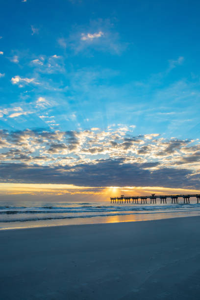 istock Sun rising over horizon and pier in Florida. 1172216361