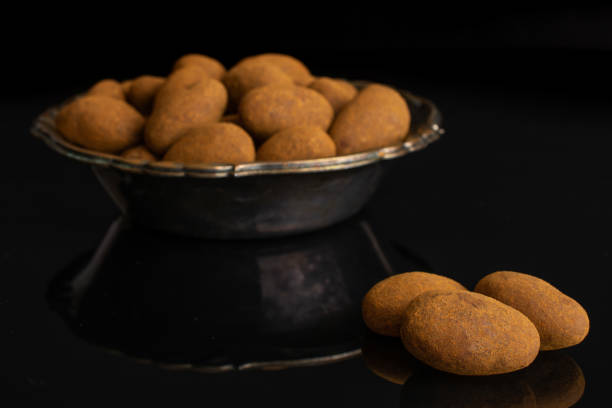 istock Chocolate cinnamon almond isolated on black glass 1172218521