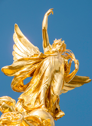 August 20, 2019 – Buckingham Palace, London, United Kingdom.  The Queen Victoria Memorial, golden statue stands tall, situated outside the Palace gates.  Outside for tourists to get up close and touch.