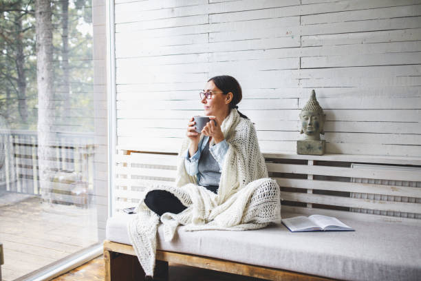 istock Woman sitting comfortable and looking through the window 1172218877