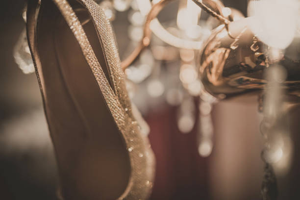white wedding shoes hanging on the chandelier