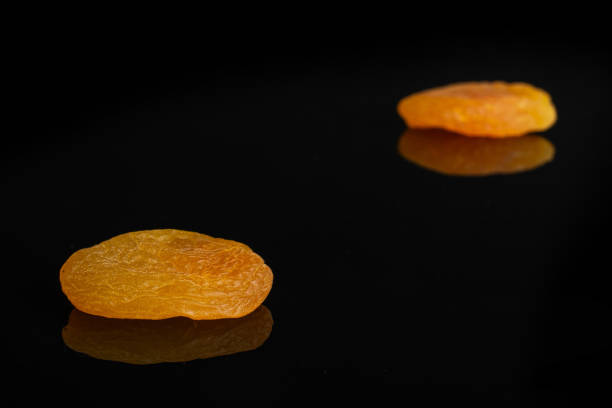 istock Dried orange apricot isolated on black glass 1172219967