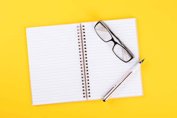istock Notebook,glasses and pen on a bright yellow background.Accessories office concept.Business Idea. Time to school.Top View.Flat Lay. Copy space for Text. 1172220176