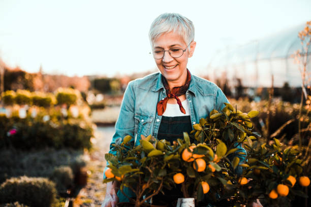 istock Gray haired woman standing over flowers 1172220921