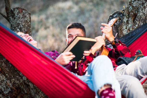istock Couple having fun in a hammock on a picnic 1172220963