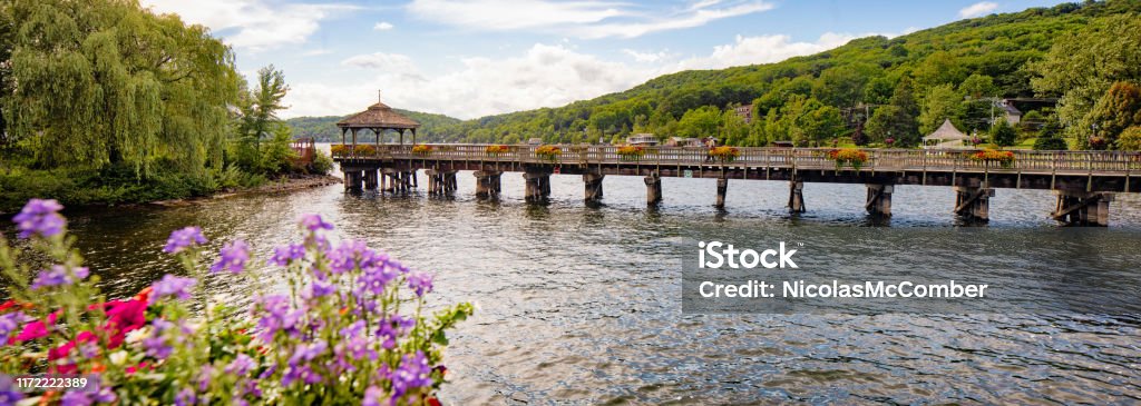 Panoramic view of North Hatley's promenade pier and gazebo in Eastern townships Quebec Panoramic view of North Hatley's promenade pier and gazebo in Eastern townships Quebec with potted flowers in the foreground. Quebec Stock Photo