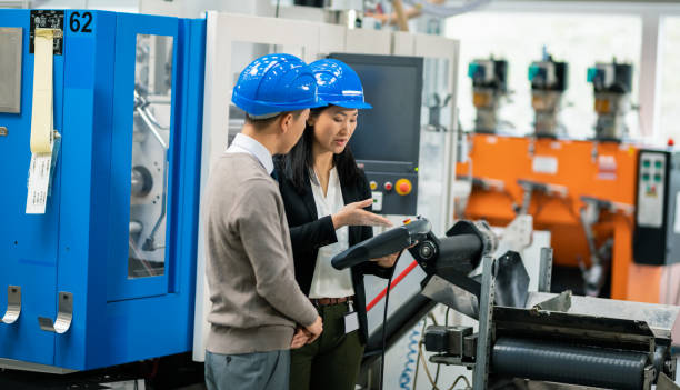 istock Asian Businessman Talking To a Female Asian Engineer Holding A Control Panel 1172222703