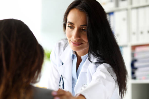 istock Mature female caucasian GP touching visitor shoulder 1172223490
