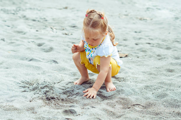 istock child playing on the sand 1172224345