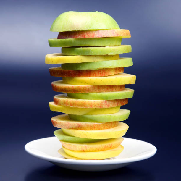 apple green sliced jigsaw covered in water droplets
