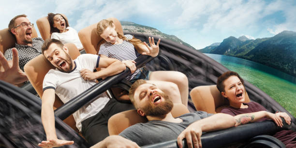istock Emotional people on the roller coaster going down wih meadows on background 1172227270