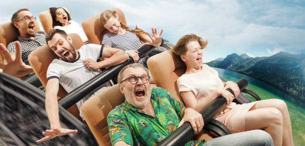 Emotional people on the roller coaster going down wih meadows on background