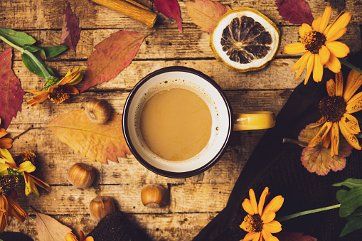 Cup of coffee and autumn season symbol for cozy feeling