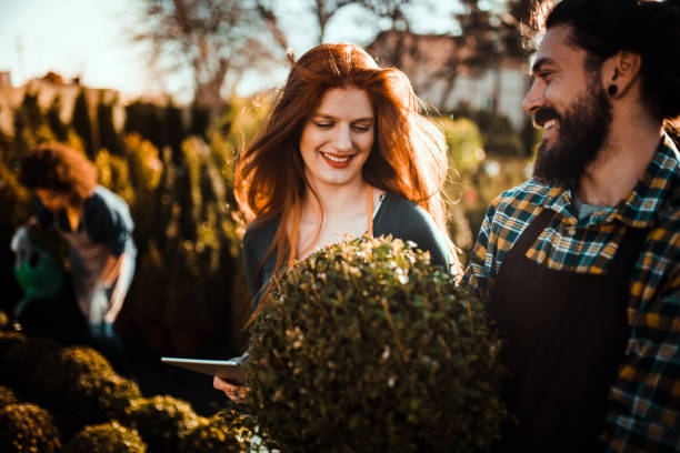 istock Couple laughing and working in a garden under the sun 1172230451