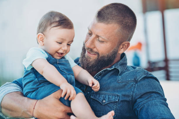 istock Young father holding his baby boy 1172231084