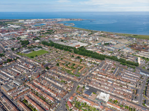 Aerial photo of the UK town of Hartlepool in County Durham, England showing rows of houses, roads and the ocean in the background. stock photo