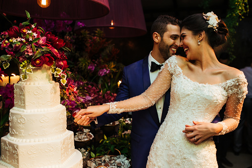 Newlyweds cutting wedding cake