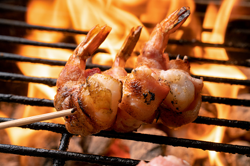 High Fat, Ketogenic Bacon Wrapped Jumbo Shrimp on a fiery old-fashioned Charcoal Grill