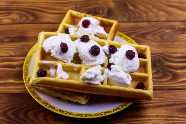istock Belgian waffles with ice cream and blackberries on wooden table 1172236139