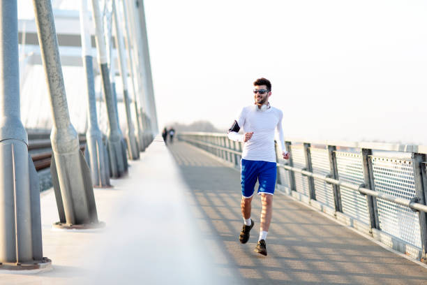istock Man jogiging on the bridge 1172239852