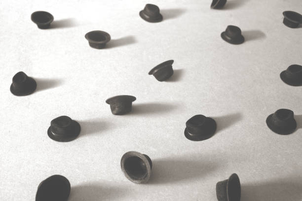 Pattern of many blue and green metal bottle caps on yellow background.