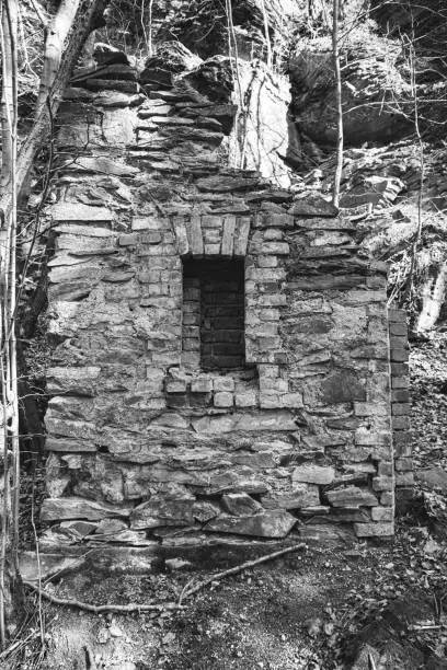 old ruin of stone in the nature as black and white picture