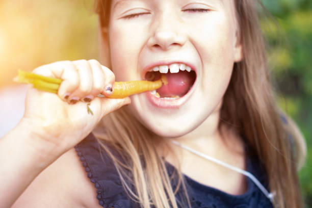 istock Girl eating carrot 1172241609