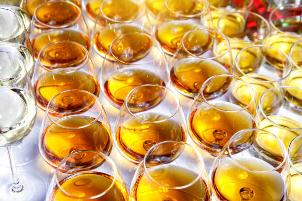 A row with glasses of alcoholic drinks at the party. Top view