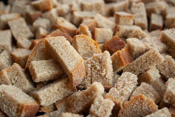 Sliced in cubes dark bread pieces crackers macro shot close up background. Bread texture. Bread backdrop