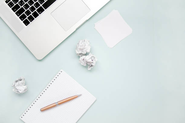 istock Work and creativity concept. Laptop, notepad, paper balls and pen top view flat lay photo with copyspace. Computer and paper work. Office above 1172243749