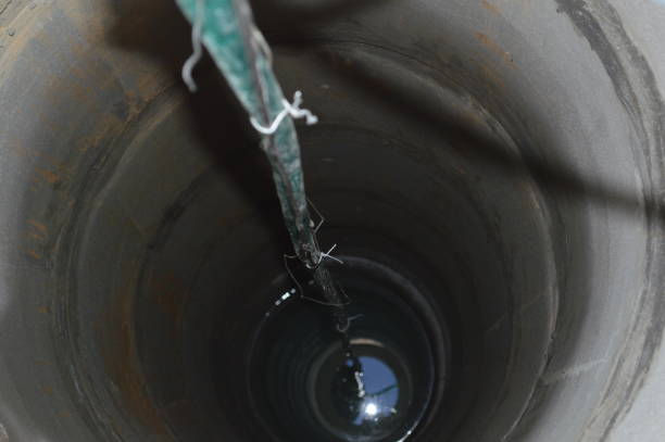 istock Installing a vibration pump in a water well 1172245363