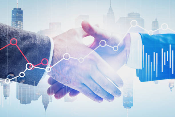 istock Handshake in city, financial graph 1172250368