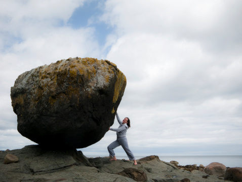 So, you think women are weak? This woman stopped this massive rock (it weighs several tons) from rolling off its precarious perch.
