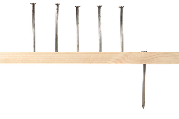 istock Nails In Wood With One Knocked through 117225406