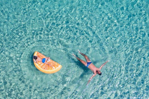 istock Drone view of swimming people 1172254953