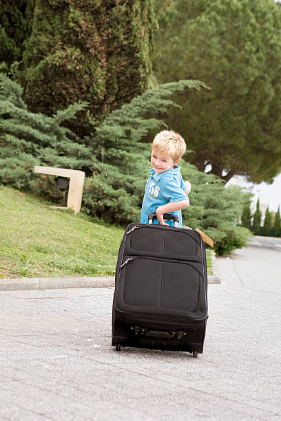 istock Independent young traveller with suitcase at airport 117226095