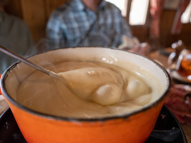 istock Bubbling cheese fondue being shared amongst friends 1172262486