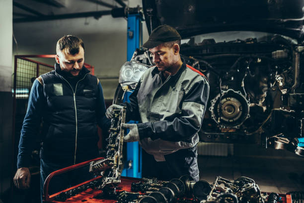 istock Mechanics repairing car engine 1172263920