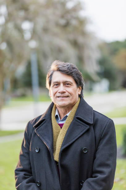 istock Senior Hispanic man in front yard wearing coat 1172265440